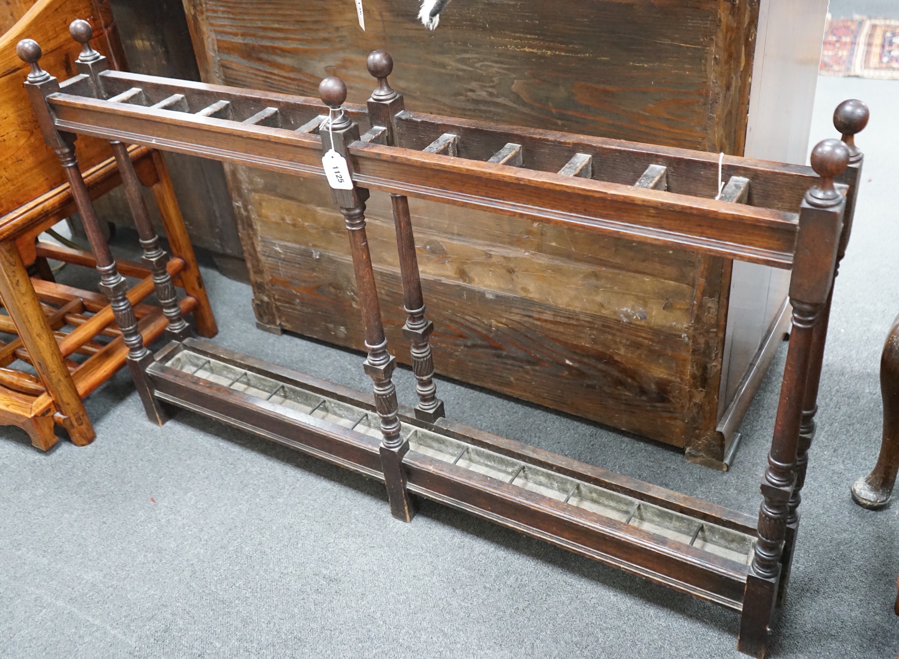 A large Victorian oak club stickstand, with zinc drip trays, width 122cm, depth 14cm, height 77cm